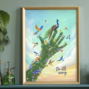 Showing a framed version of our Do Not Worry Art Print with a tree in the shape of a hand and loads of colourful birds flying around or perching on it, with the phrase 